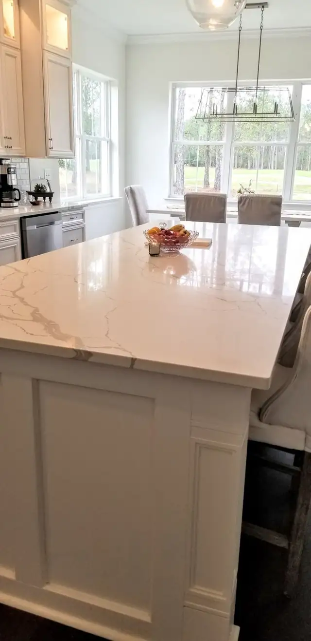 White quartz island countertop with soft gray veining and a squared edge